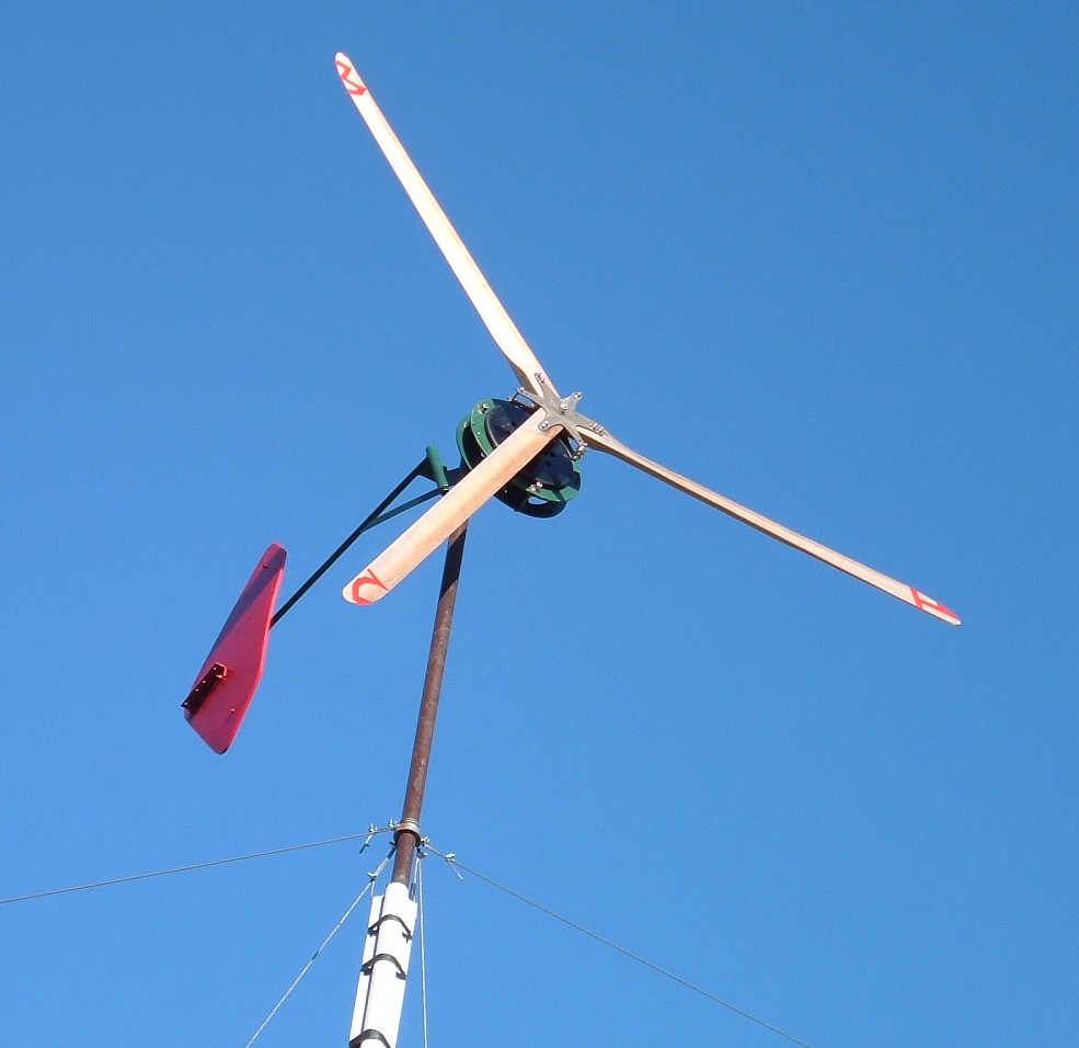 Axial flux wind generator having three 2x4 wooden blades with 10 foot diameter