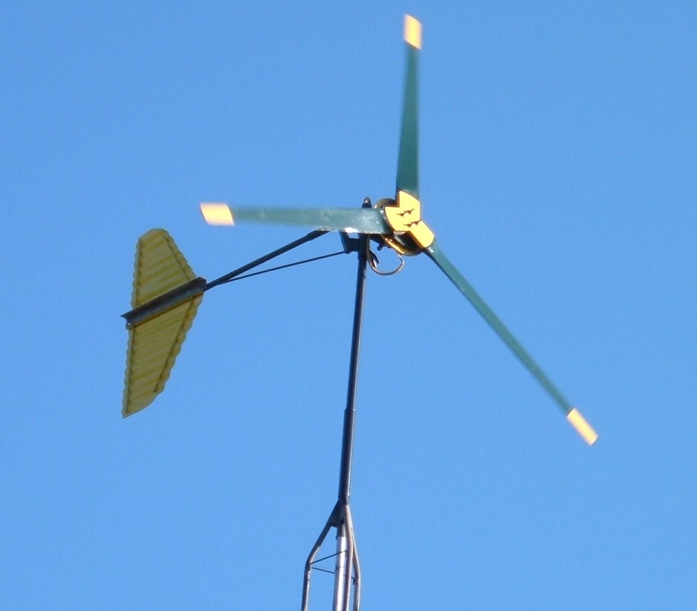Axial flux wind generator having three 2x6 wooden blades with 10 foot diameter