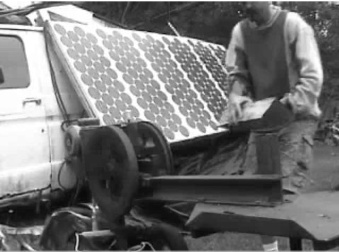 Electric Woodsplitter next to a rack of solar panels