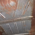 Above the gas tank - underside of trunk floor